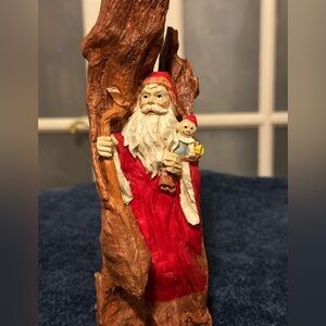 Intense resin Santa looks out from between the cliffs. Very different.